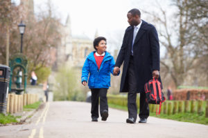 Father Walking Son To School Along Path