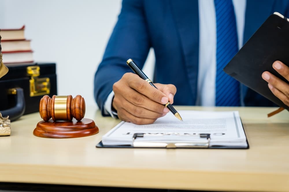 Lawyer in a formal suit handles contracts, agreements, legal obligations, and considerations of rights and liberties, focusing on constitutional and human rights in legal practice.