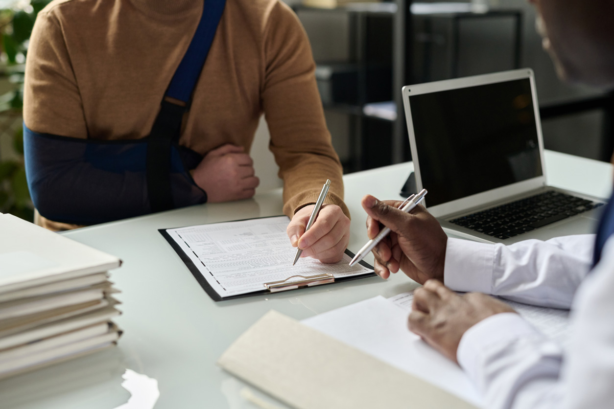 man filling in medical insurance form