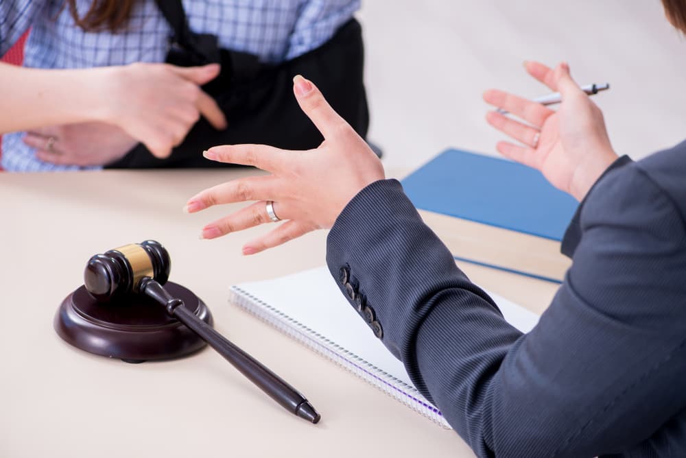 Employee consulting a lawyer about insurance claims after an injury