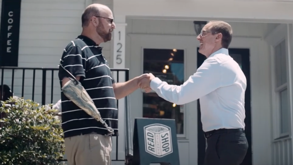 Stephen Hasner shaking a former workers' comp client's hand at an Atlanta coffee shop