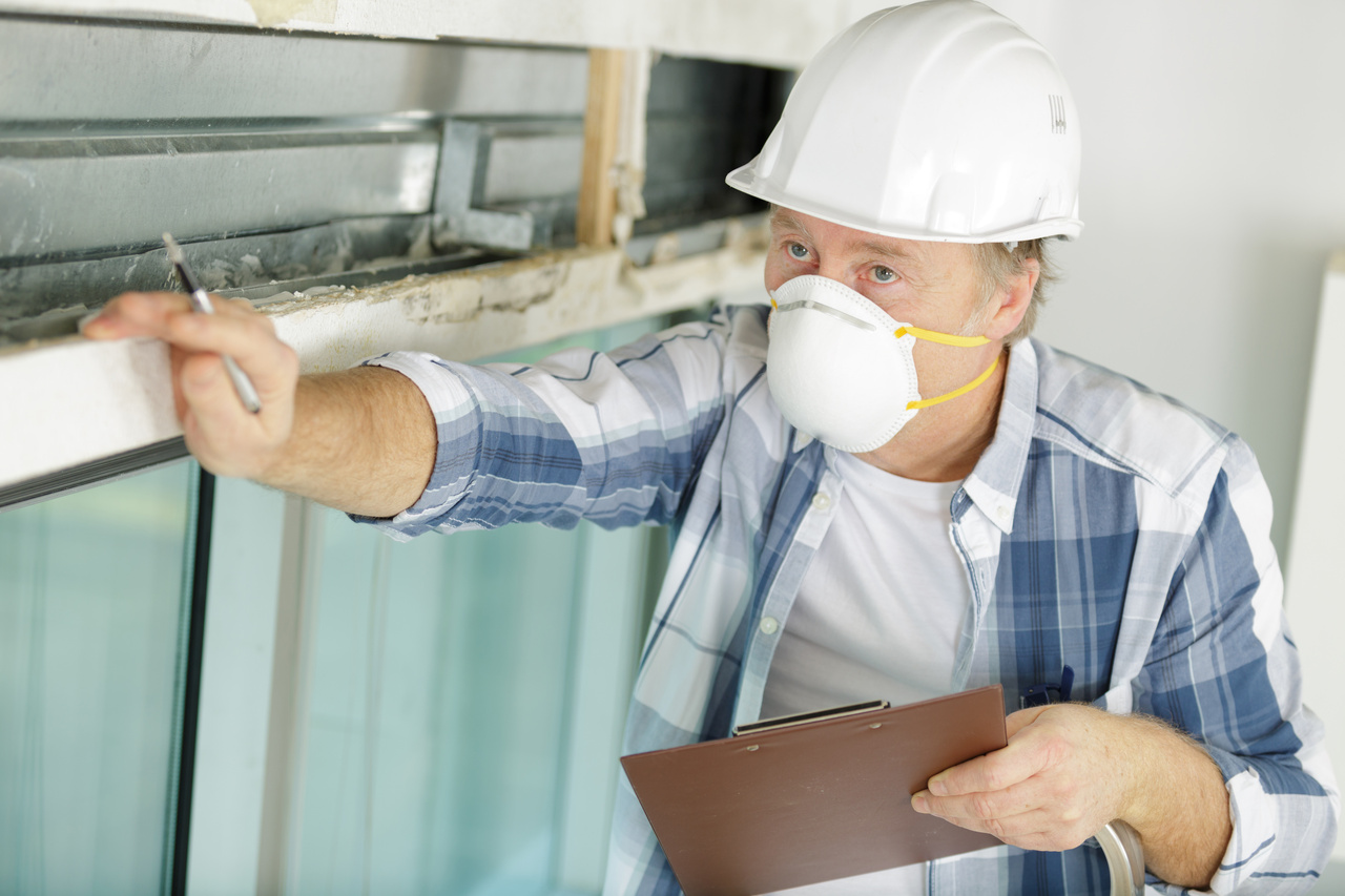 mature man inspecting property wearing face mask