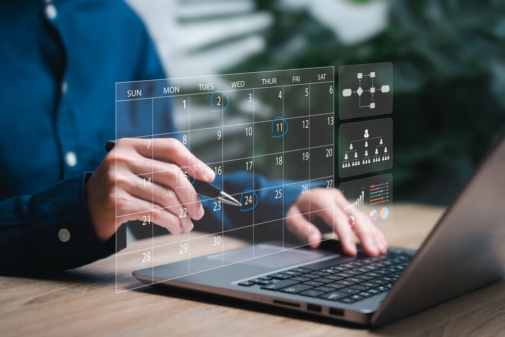 person working at computer looking at calendar